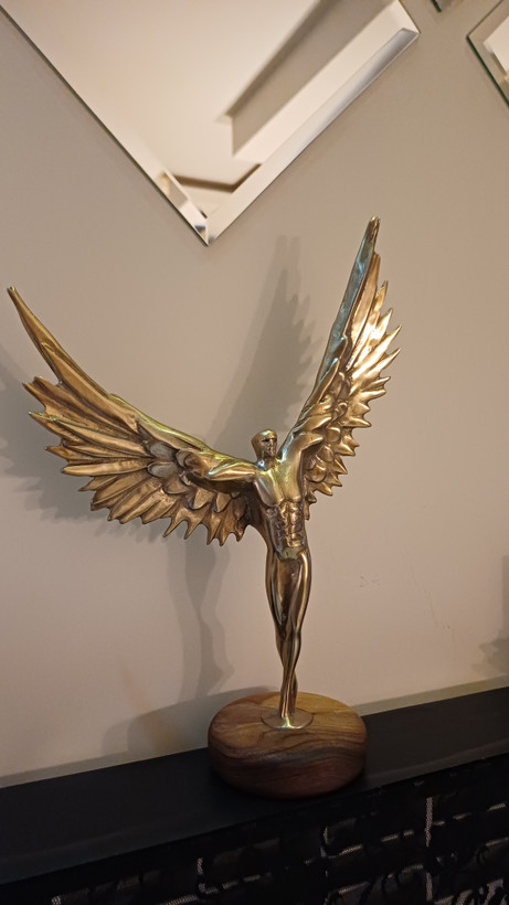 Modern decorative bodybuilding statue with angel wings crafted from shiny aluminum