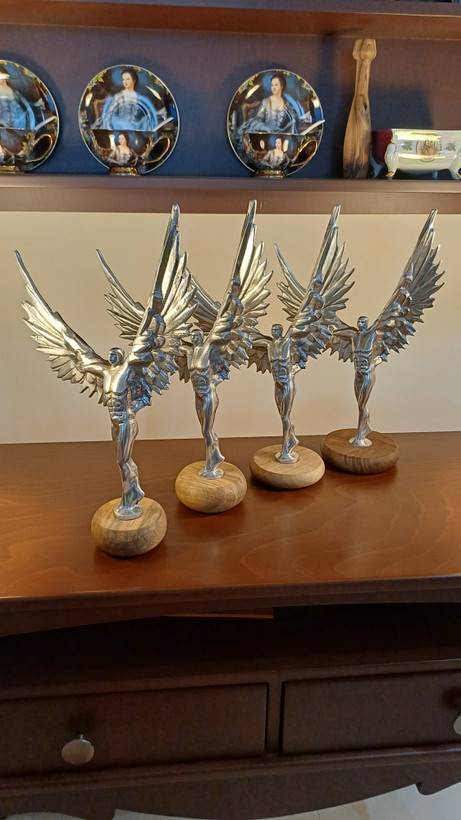 Decorative metal art sculpture of muscular man with angel wings – contemporary fitness décor piece