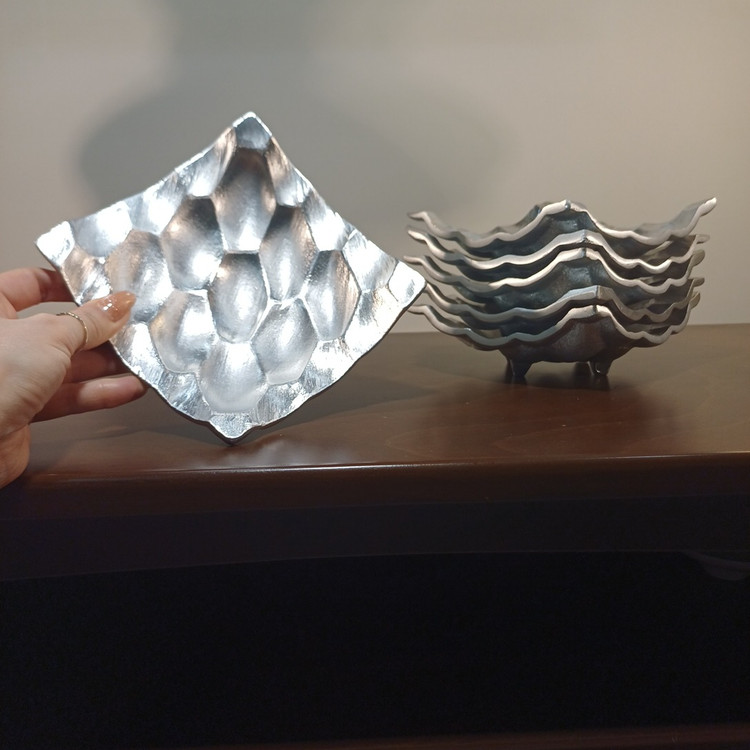 Glossy aluminum honeycomb serving dish with a rolled inner edge, designed for desserts.