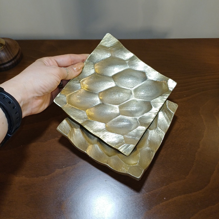Close-up view of the intricate honeycomb pattern on an aluminum serving tray, ideal for sweets.