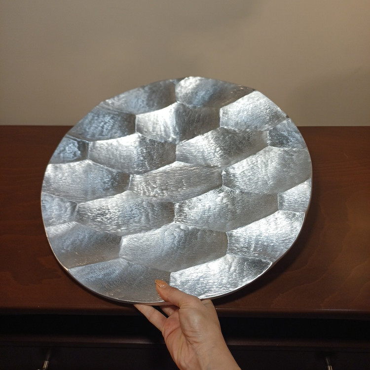 “Round aluminum serving tray with honeycomb pattern and curved edge, perfect for snack presentation.”