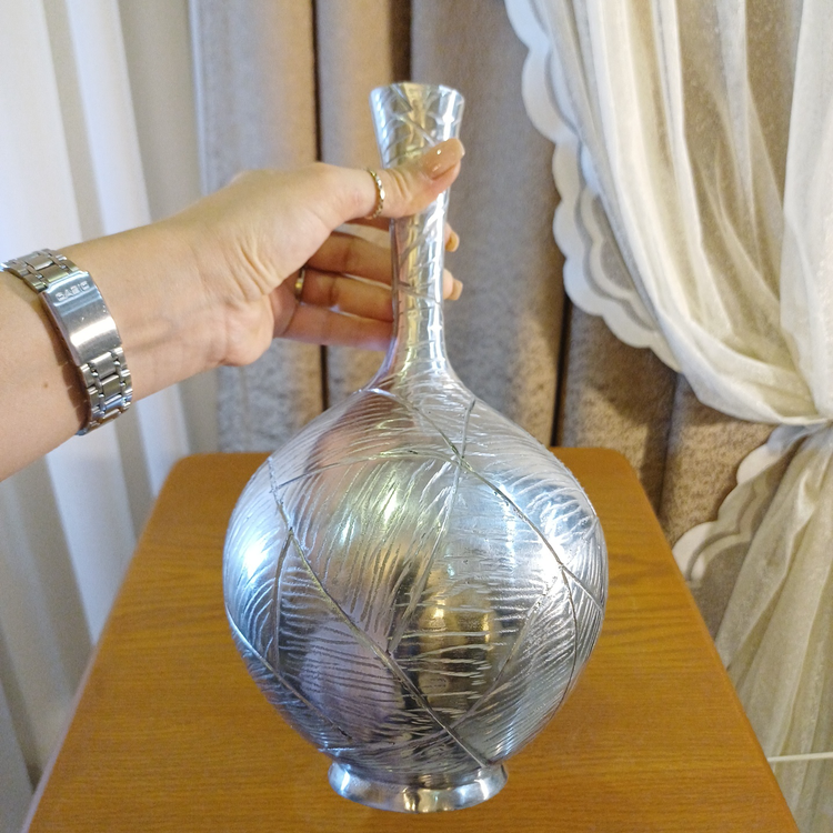 Vinah decorative aluminum vase with an embossed wheat (grain) design, showcasing the intricate pattern in warm metallic tones.