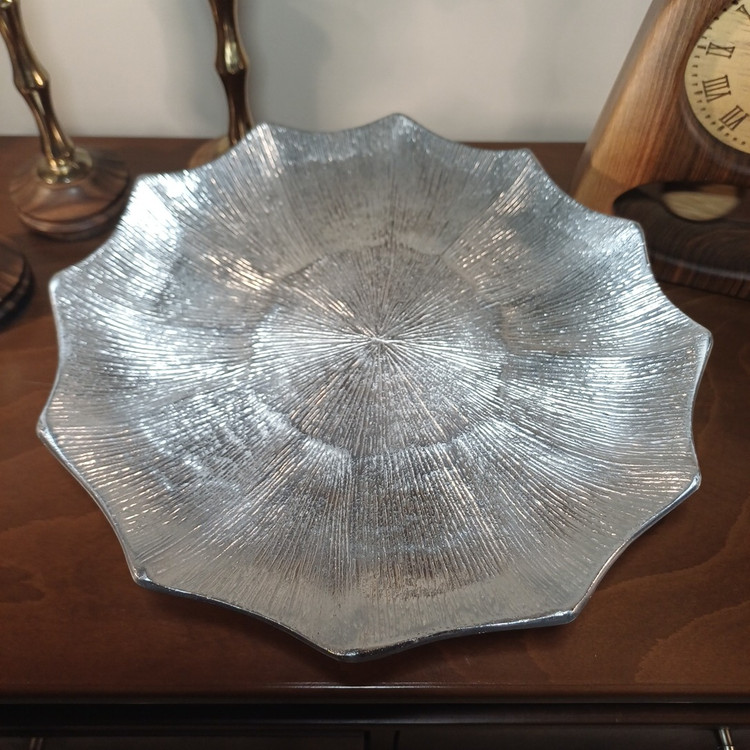 Decorative aluminum pedestal cake plate featuring a sleek linear pattern and metallic finish.