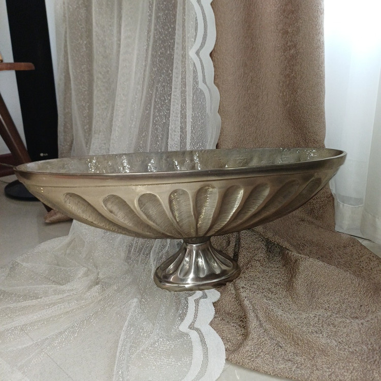 Contemporary aluminum vase with artistic curved form, suitable for decorative interior styling.