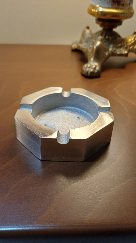 Modern aluminum ashtray with a simple elegant design and smooth metallic finish.