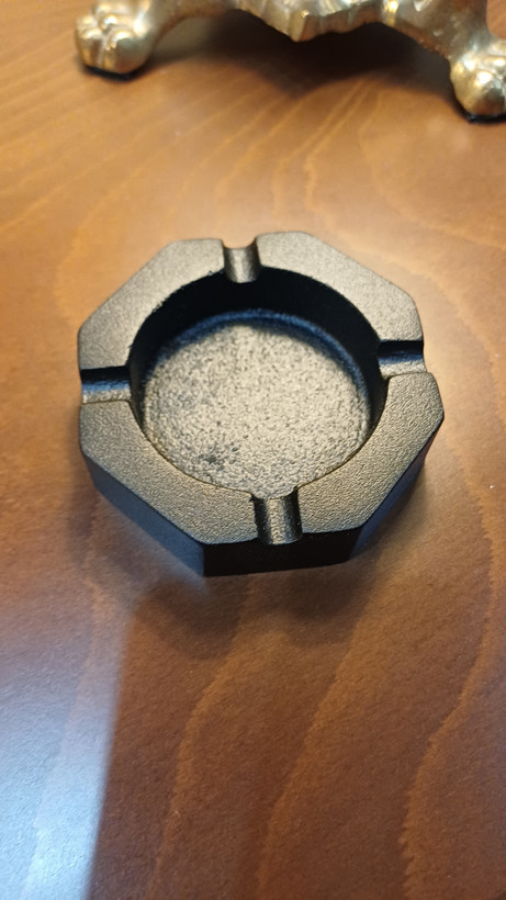 Decorative aluminum ashtray with a sleek modern style, ideal for home or lounge settings.