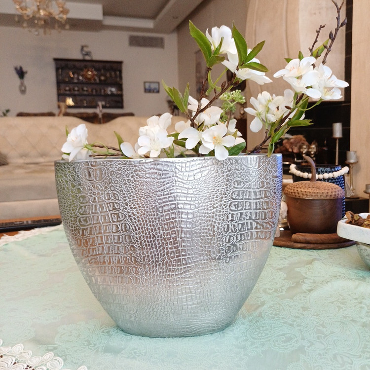 Decorative aluminum vase with a snake-skin inspired texture, modern shape, and elegant metallic finish.