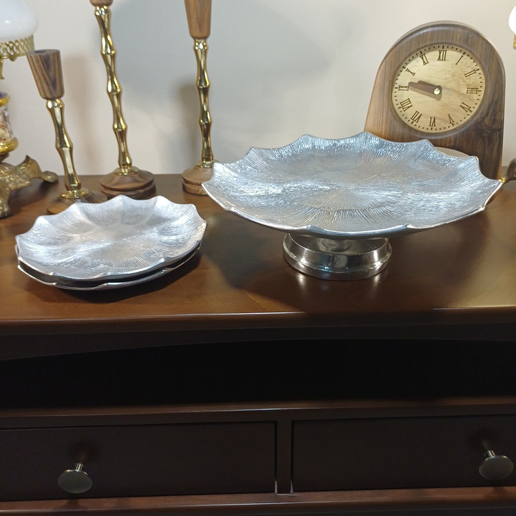 Modern decorative serving plate made of aluminum with a refined liner-style texture.