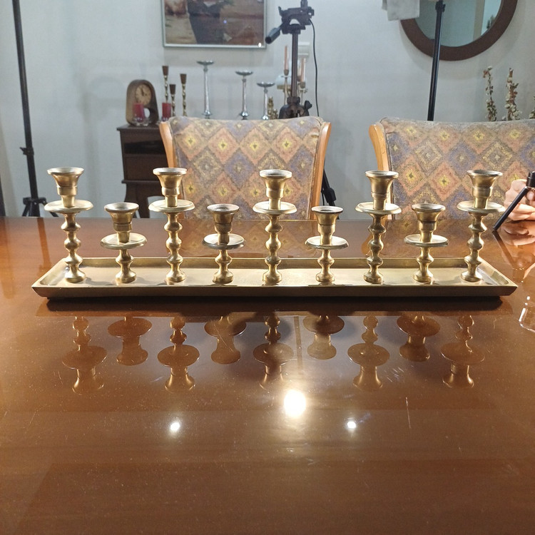 Luxurious modern aluminum candelabrum with nine elegant candle holders and sleek geometric design.