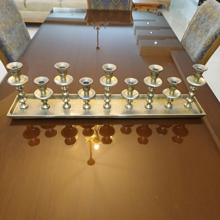 Stylish aluminum candelabrum featuring a contemporary look with nine candle slots, perfect for upscale decor.