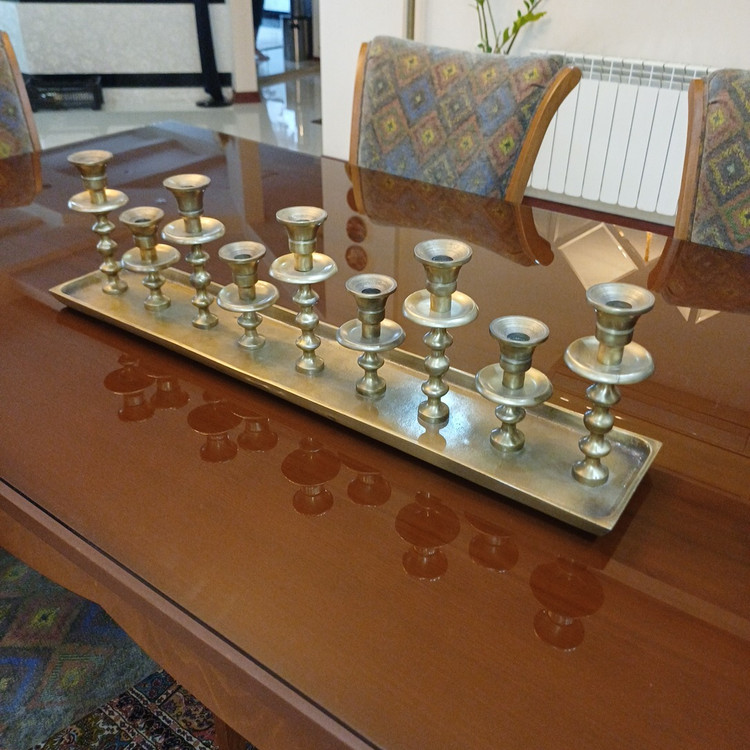 Chic aluminum candle holder with nine branches, combining modern design and sophisticated style.