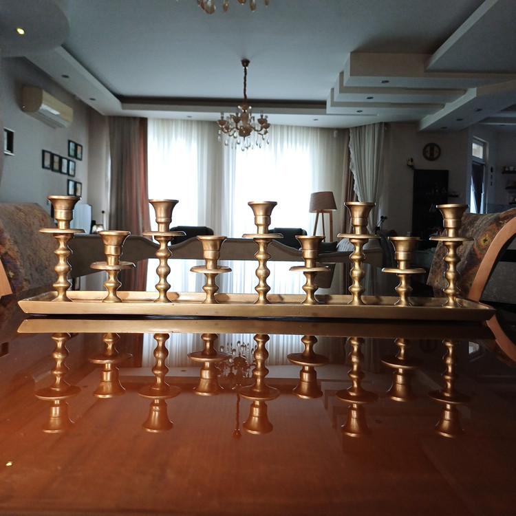 Elegant nine-arm aluminum candelabra with a shiny finish and modern geometric pattern for luxurious settings.
