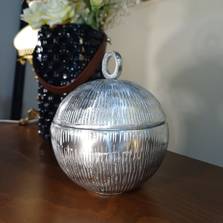 “‘Planet’ aluminum centerpiece. 19cm spherical design with striking embossed pattern. Sophisticated, minimalist aesthetic.”