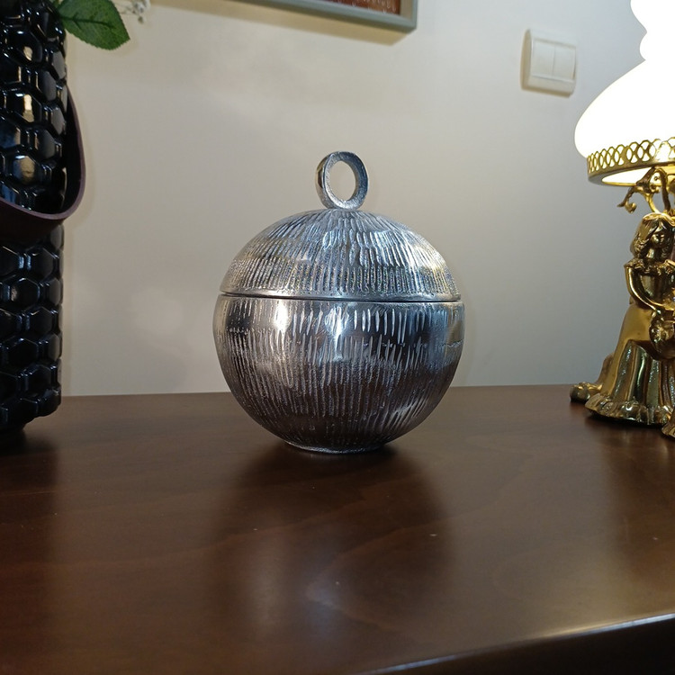 “‘Planet’ aluminum container. Captivating sphere, rich textured surface. Inspired by planetary orbits.”
