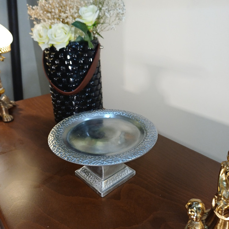 “Set of two hammered aluminum pedestal serving bowls. Hand-finished texture for a luxurious, artisanal look. Perfect for elegant entertaining.”