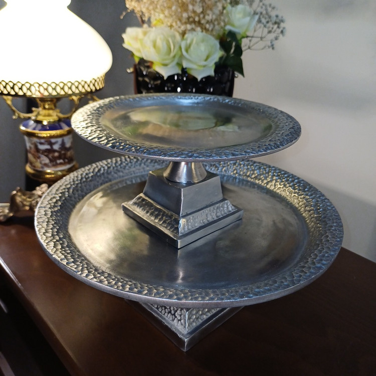 “Artisanal aluminum serving bowls on stands. Featuring a unique hammered pattern and metallic sheen, ideal for displaying snacks or fruits.”