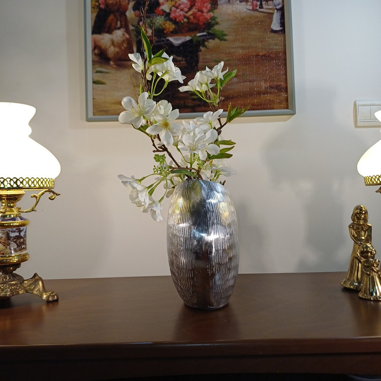 “Elegant aluminum vase named ‘Mahtab’, designed with intricate vertical patterns and a stylized knot accent. A sophisticated addition to any decor.”