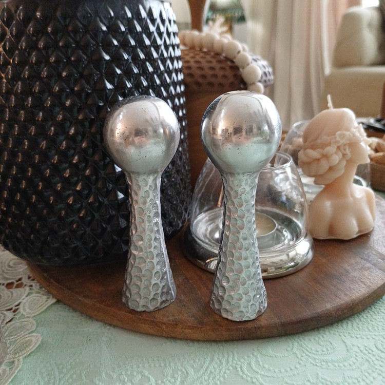 Modern aluminum salt shaker with a hammered texture, featuring a sleek and elegant design for contemporary dining tables.