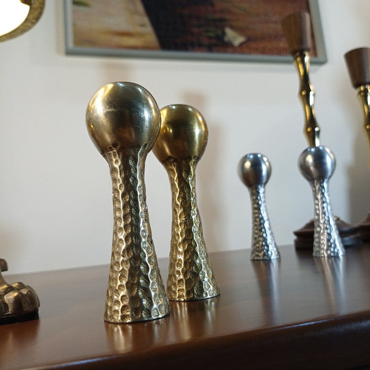 Close-up of a modern hammered aluminum salt shaker, designed for elegant table settings and everyday use.