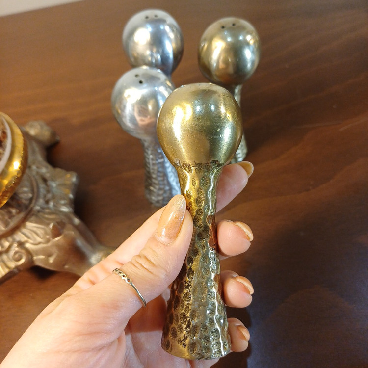 Decorative aluminum salt shaker with a hammered surface, adding a refined and modern touch to the dining experience.