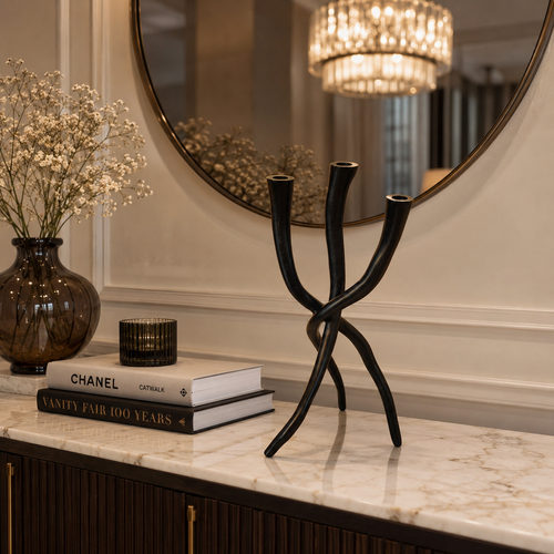 Modern black three-arm candle holder on luxury marble console