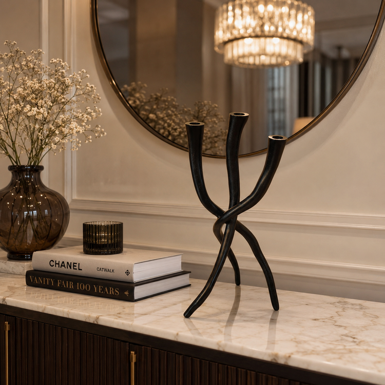 Modern black three-arm candle holder on luxury marble console