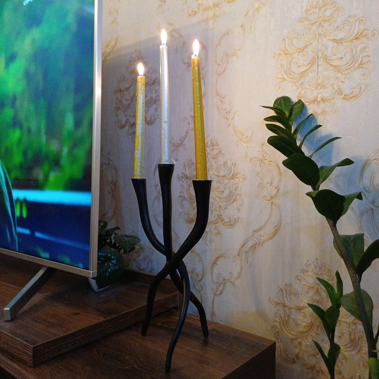 Minimal twisted black candlestick centerpiece in elegant interior